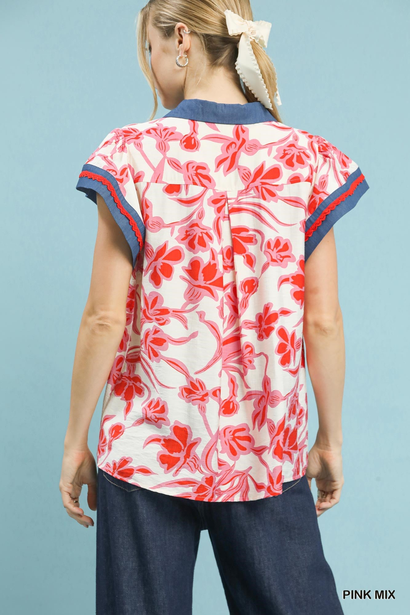Back view flutter top with pink-and-white floral print and navy-edged neckline