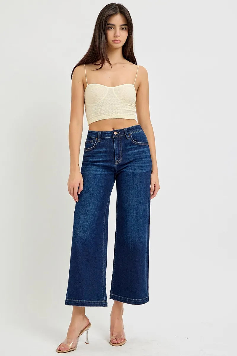 High-rise wide-leg jeans in dark blue denim, button fly, belt loops, and front pockets