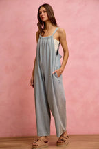 Light blue denim wide-leg overalls with spaghetti straps and relaxed straight fit