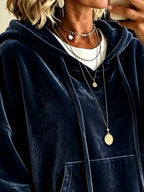 Navy velvet hoodie with hood and kangaroo pocket, shown close-up at chest