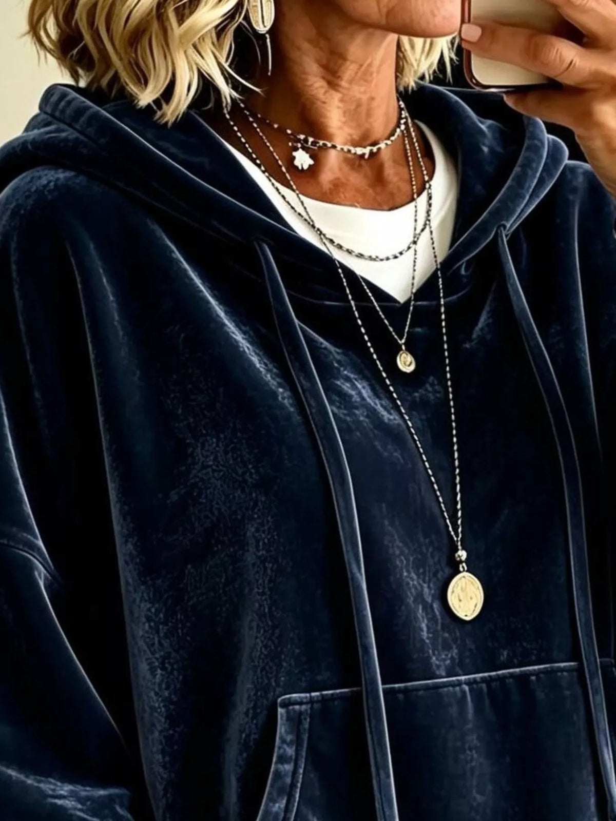 Navy velvet hoodie with hood and kangaroo pocket, shown close-up at chest