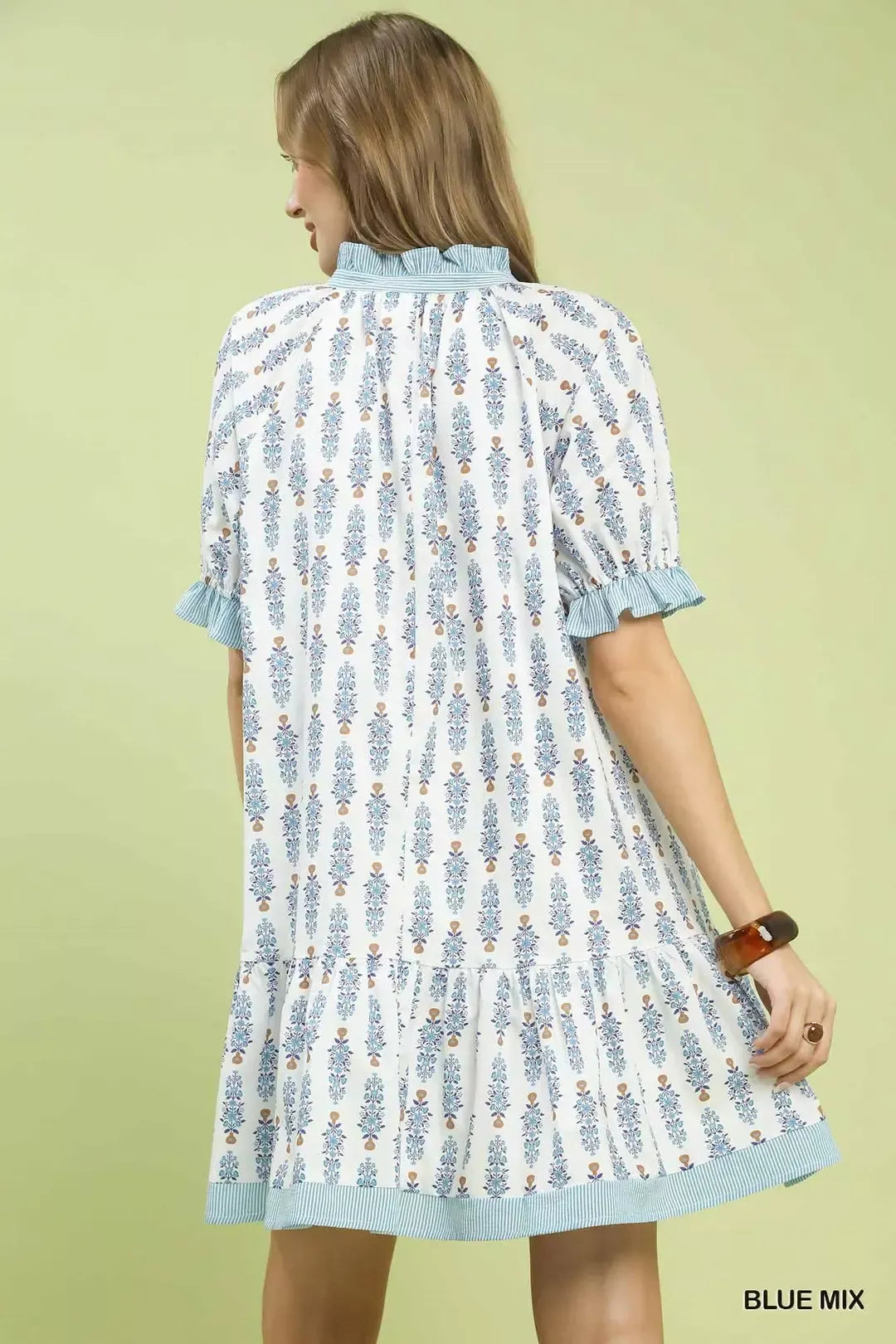 Light blue floral-print tiered mini dress back view with ruffle sleeves and gathered yoke