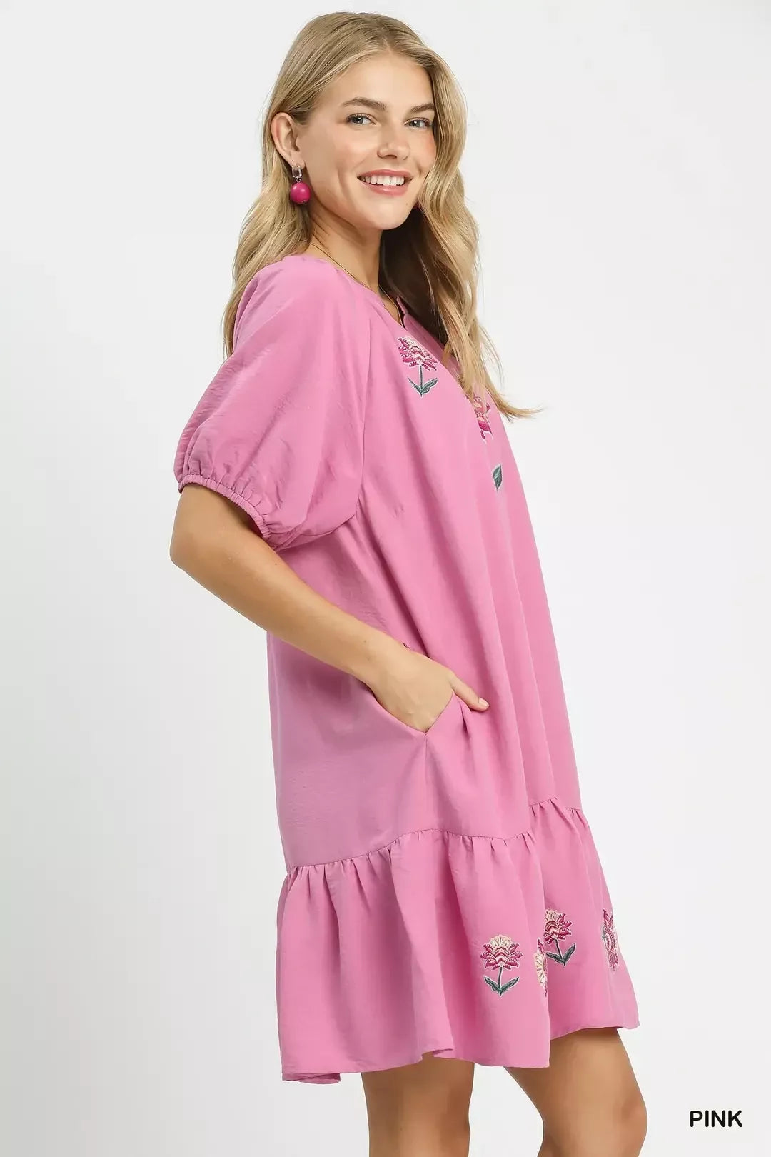 Pink babydoll dress with short puff sleeves and embroidered floral hem