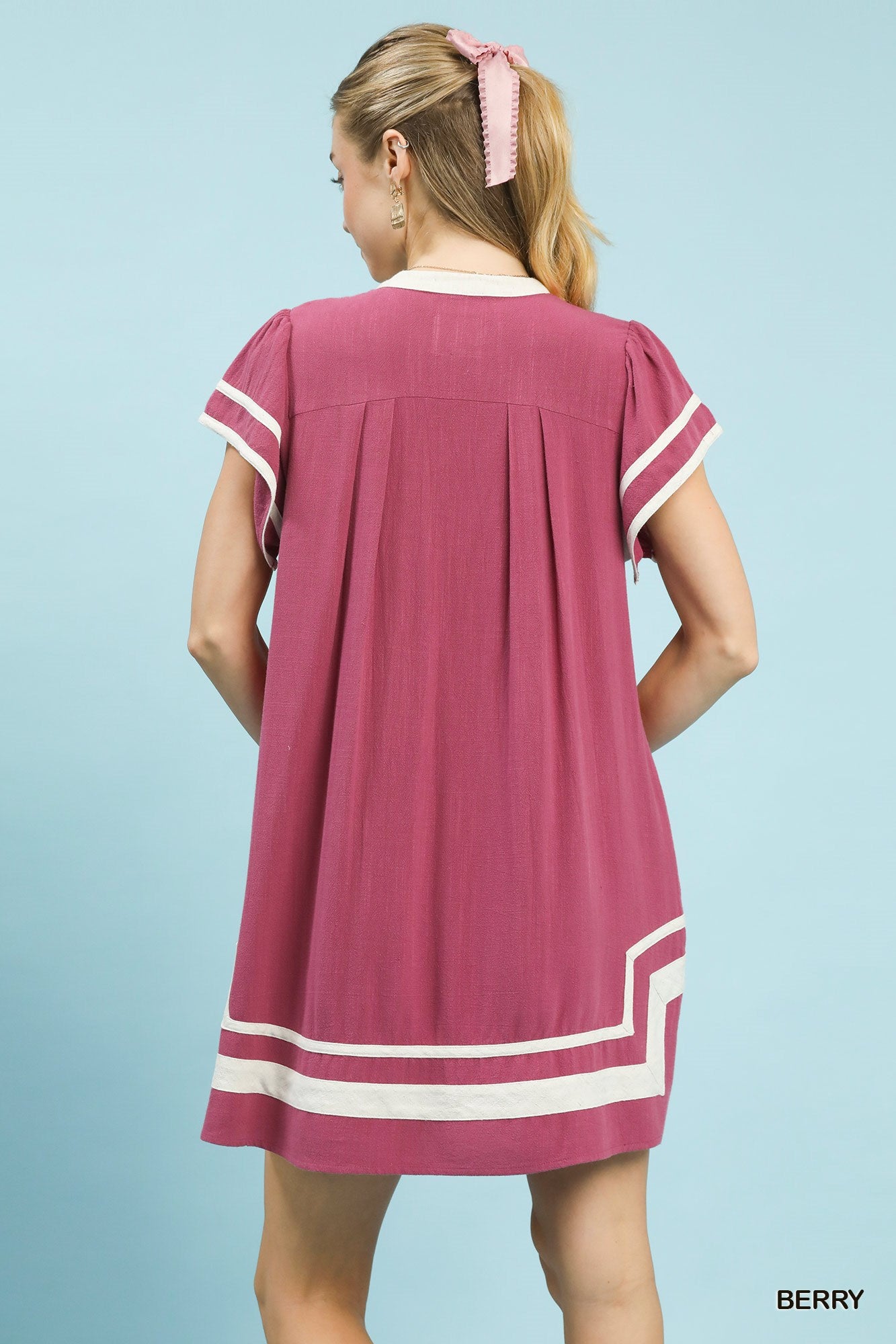 Berry linen short-sleeve dress with back yoke pleats and white contrast trim hem.