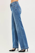 Women's high-rise wide-leg jeans, medium blue denim, side view with released hem