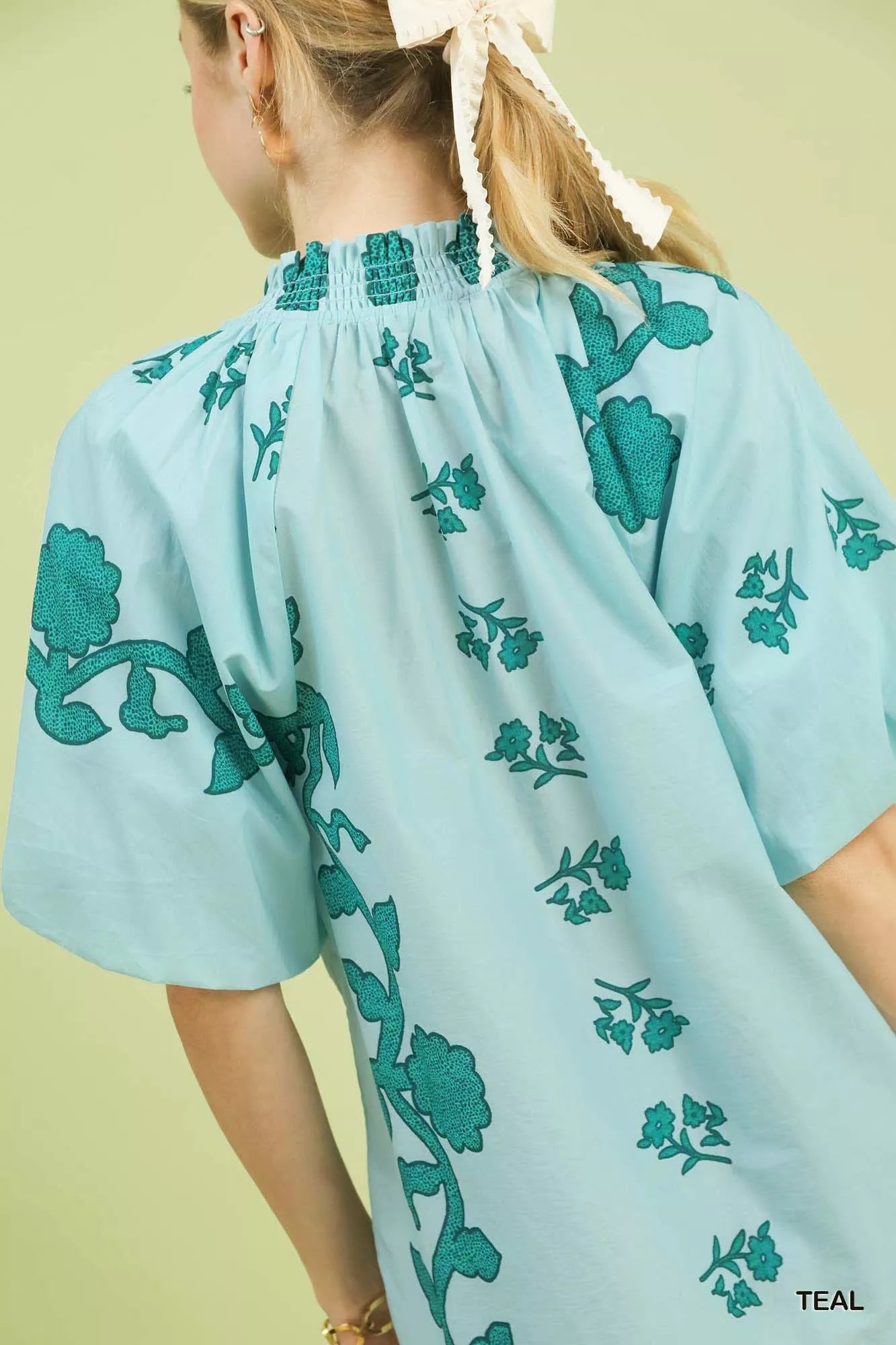 Women's teal floral cotton blouse with gathered smocked yoke and puff sleeves