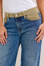 Women’s blue stretch jeans with tan corduroy waistband, front pockets and belt loops