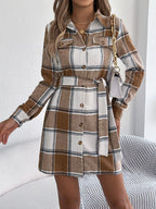 Plaid belted shirt dress in khaki-brown, long sleeves, button front, tie waist.