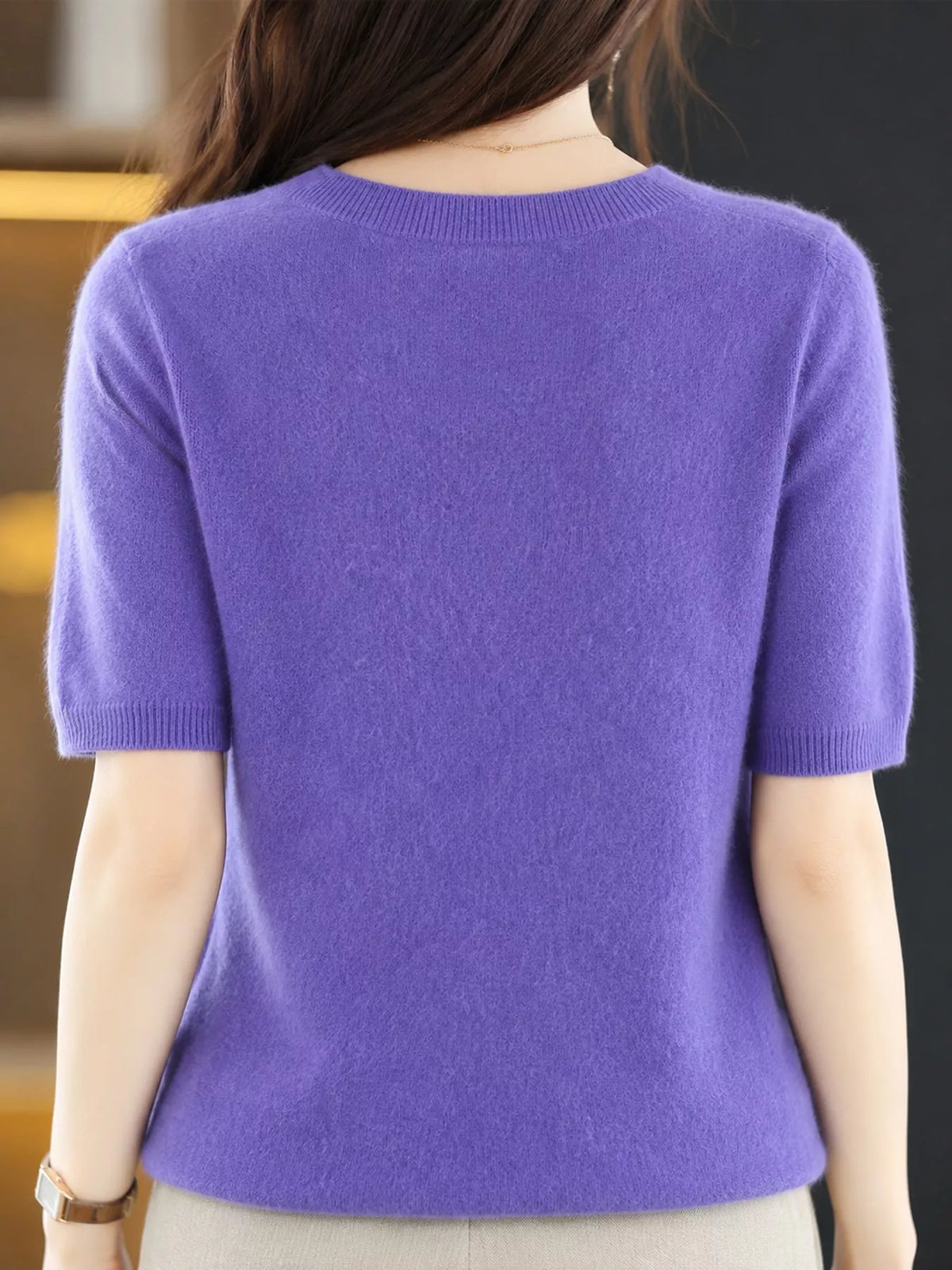 Lavender purple round-neck short-sleeve sweater, back view with ribbed hem