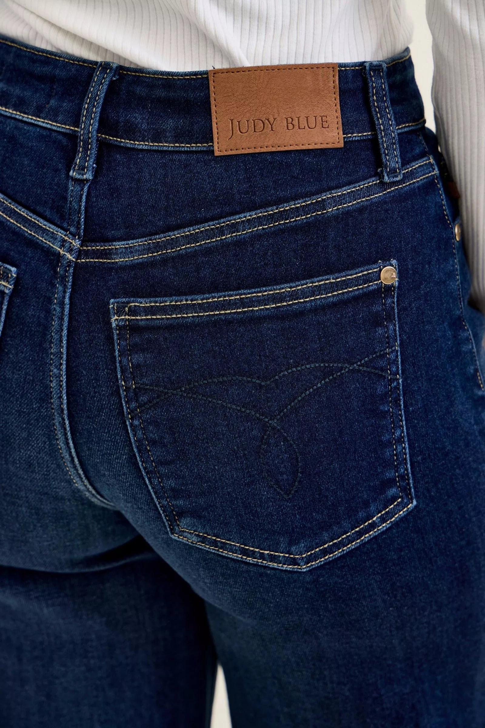 Dark wash denim pocket close-up with JUDY BLUE leather label