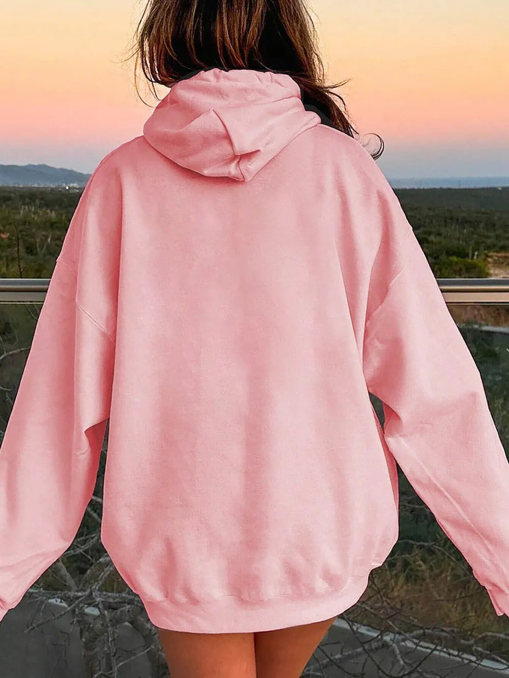 Blush pink back view hoodie with drawstring hood and relaxed dropped-shoulder fit