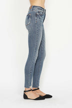 Medium wash skinny jeans with back yoke, belt loops, and stitched pockets, button-zip closure.