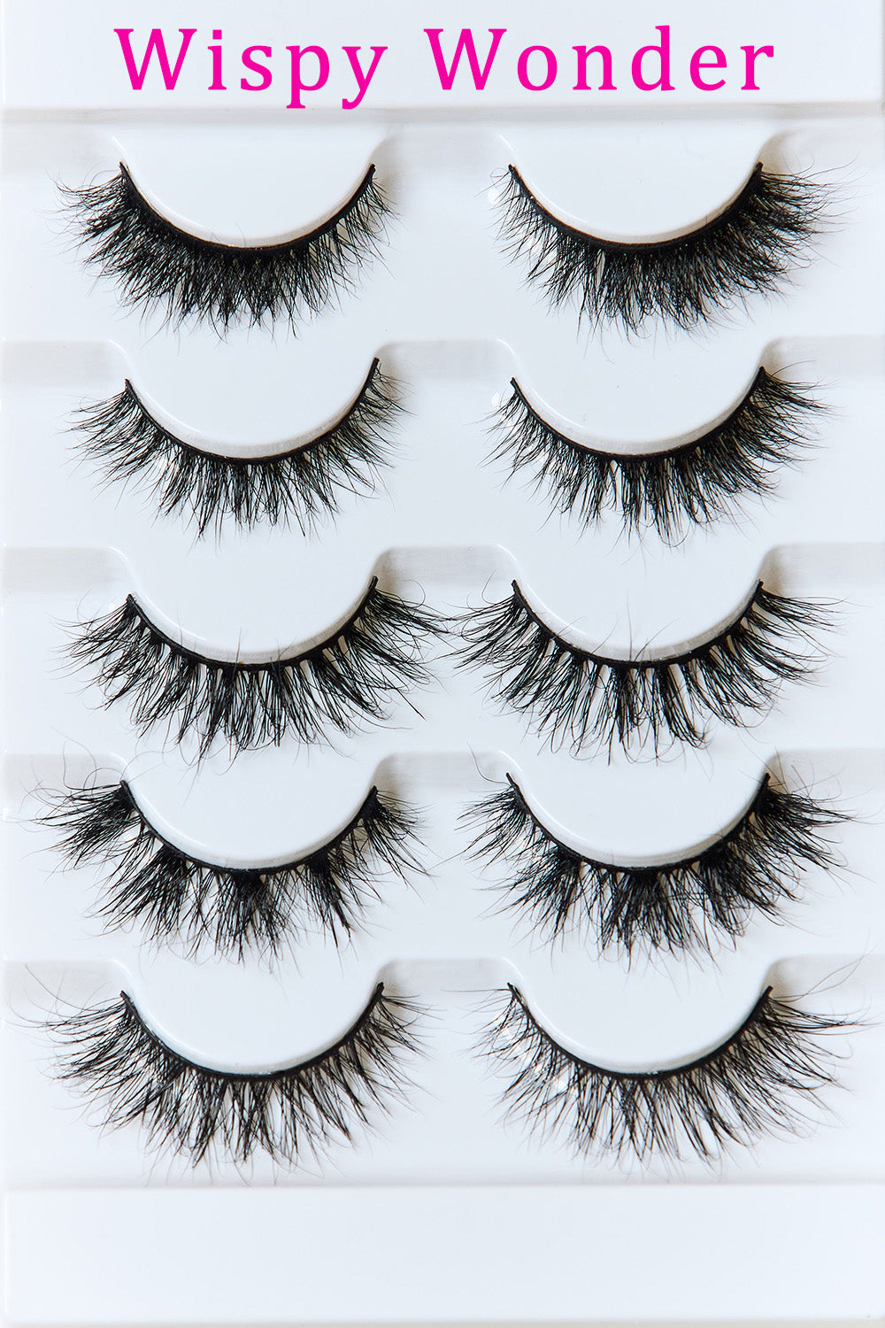 Wispy Wonder mink false eyelashes, multiple black lash pairs laid on white tray