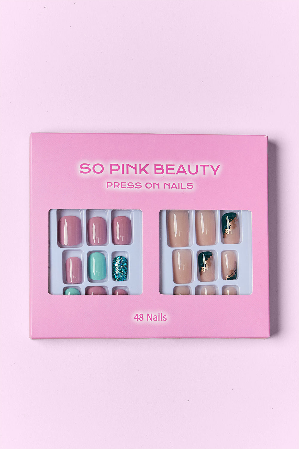 Press-on nail set in pink display box, featuring nude, mauve, and teal-green glitter nails